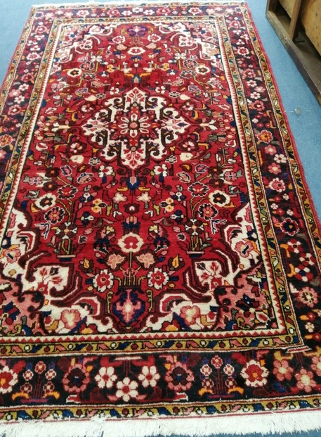 A Persian red ground carpet 260 x 150cm